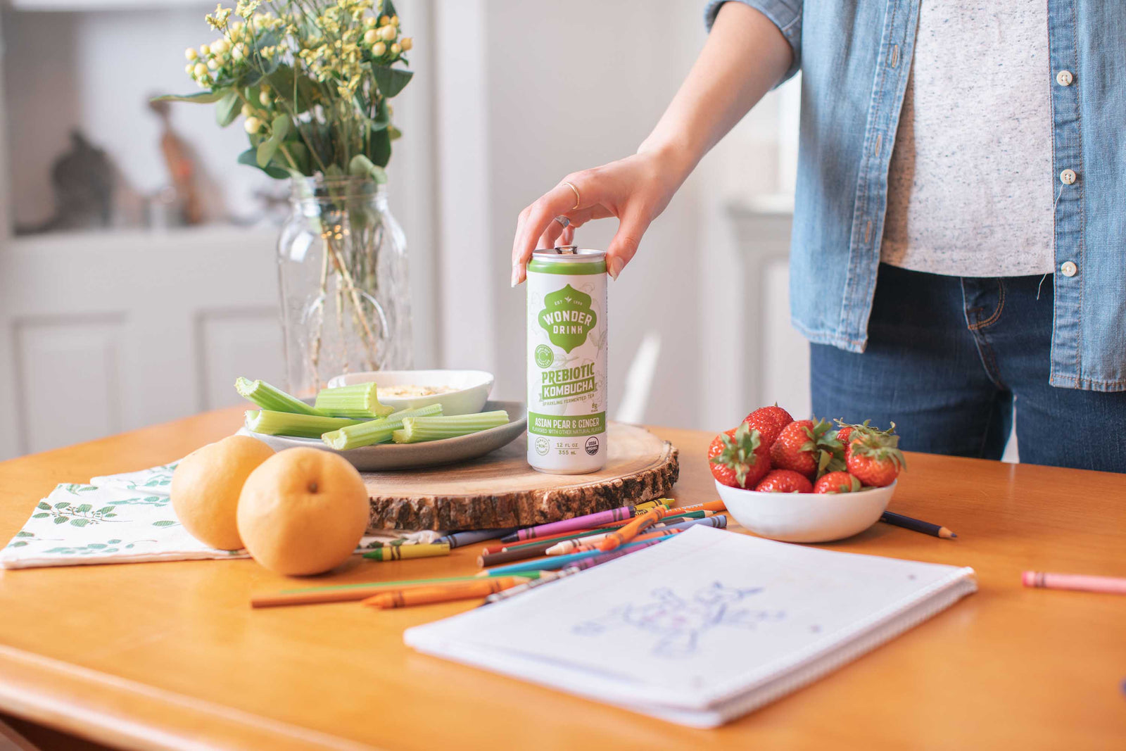 Messy Kitchen table with can of Wonder Drink Kombucha