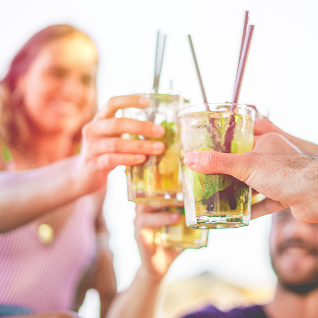 woman raising a glass to toast with friends
