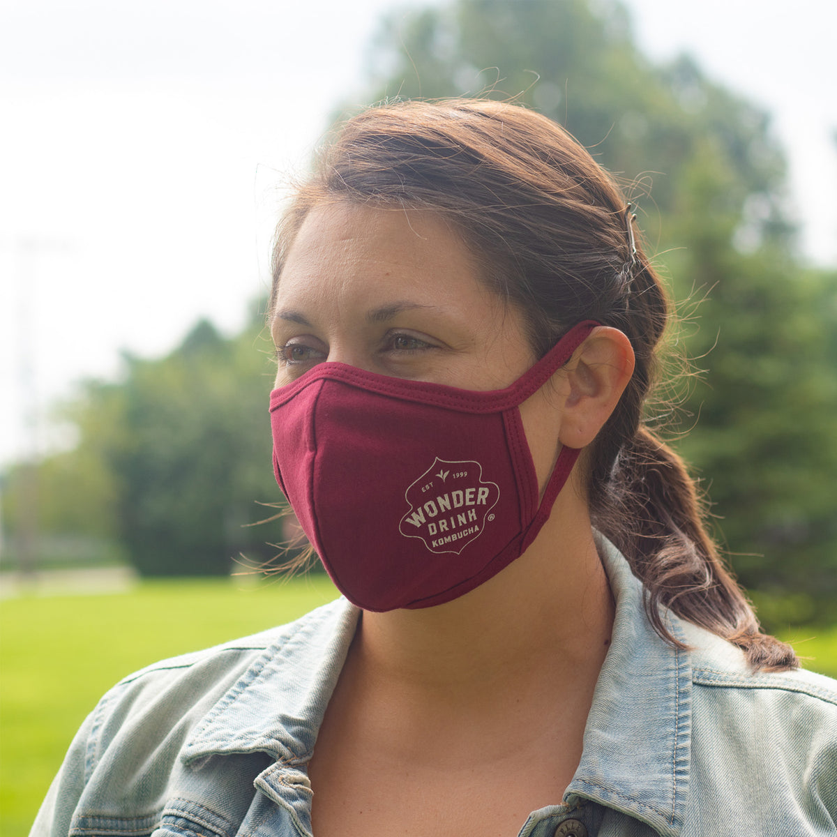 a woman wearing a wonder drink face mask